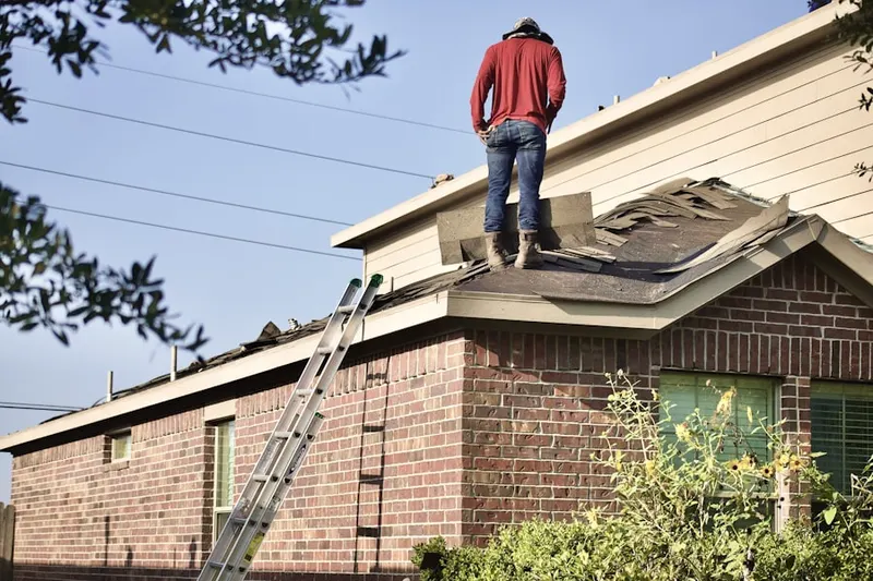 Professional roofer working on a residential roof in Whitehouse Station